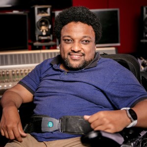 An image of Samson sitting in his motorised wheelchair in a music studio.